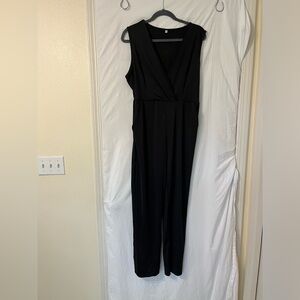 Black jumpsuit. Causal or dressy. V-neck with pockets.